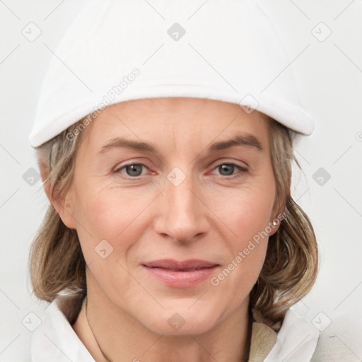 Joyful white adult female with medium  brown hair and grey eyes