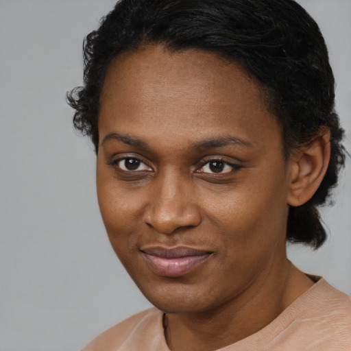 Joyful black young-adult female with short  brown hair and brown eyes