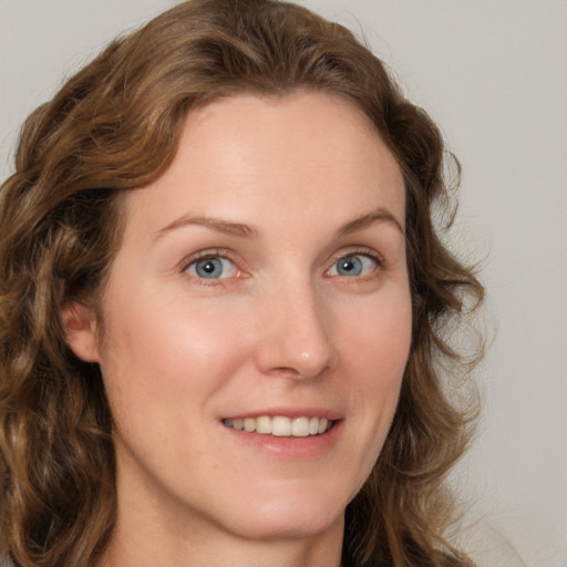 Joyful white young-adult female with medium  brown hair and green eyes