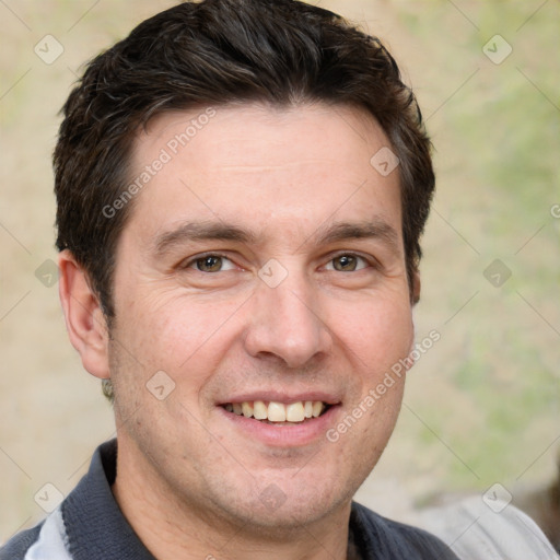 Joyful white adult male with short  brown hair and brown eyes