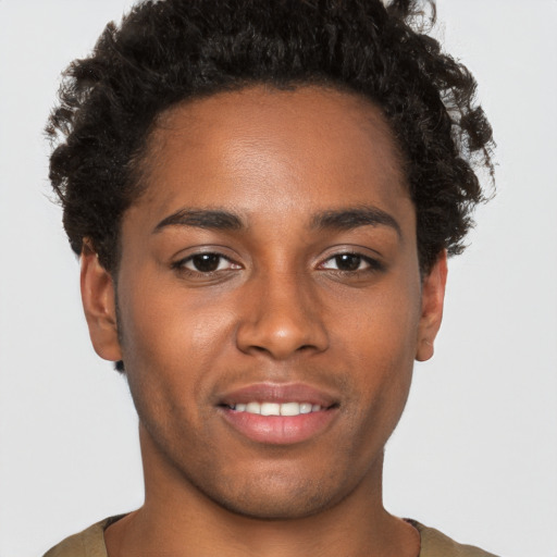 Joyful black young-adult male with short  brown hair and brown eyes