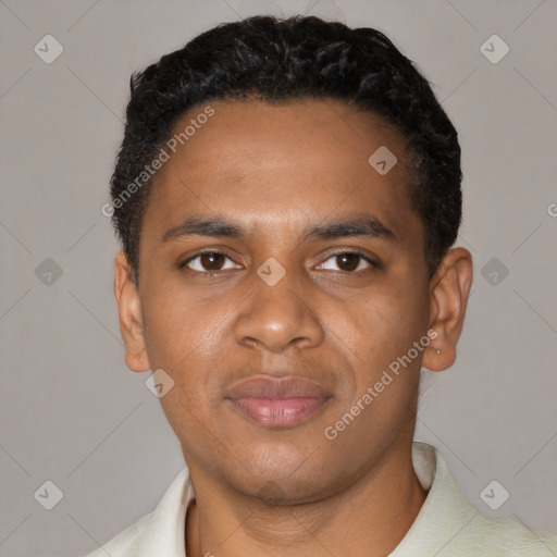 Joyful black young-adult male with short  black hair and brown eyes
