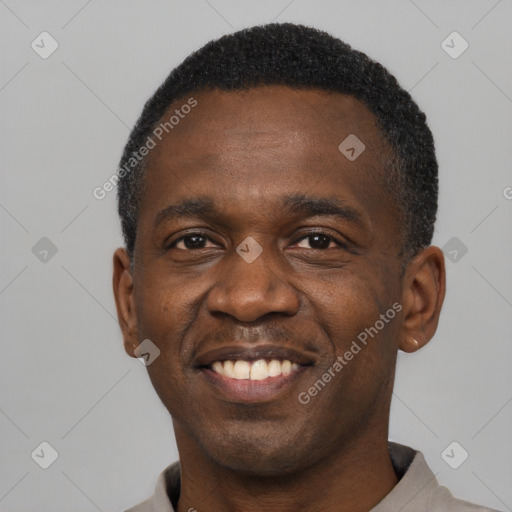 Joyful black adult male with short  black hair and brown eyes