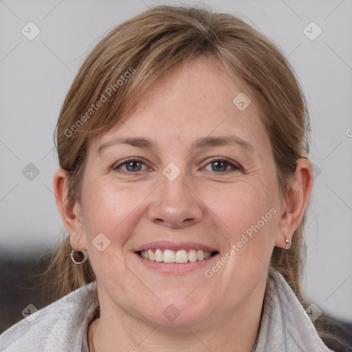 Joyful white adult female with medium  brown hair and grey eyes