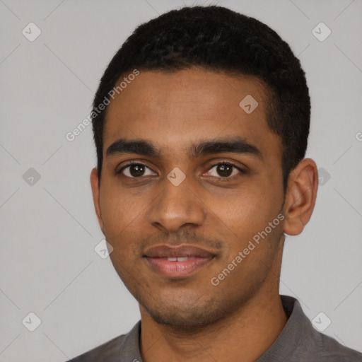 Joyful black young-adult male with short  black hair and brown eyes