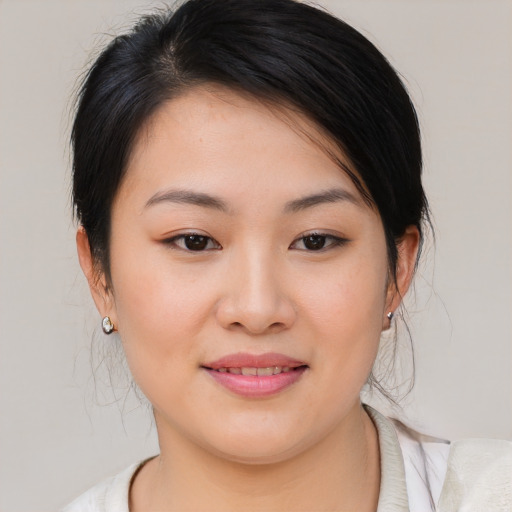Joyful asian young-adult female with medium  brown hair and brown eyes