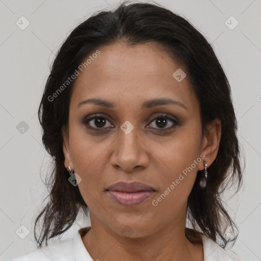 Joyful black adult female with medium  brown hair and brown eyes