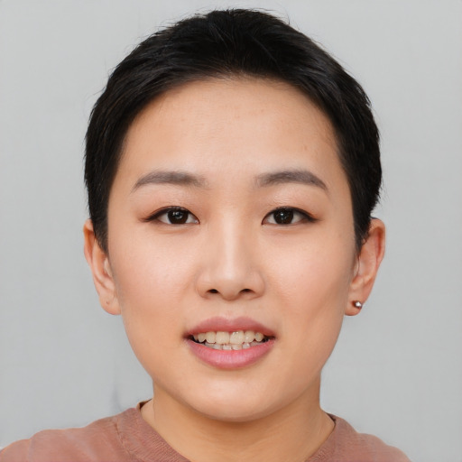 Joyful asian young-adult female with short  black hair and brown eyes