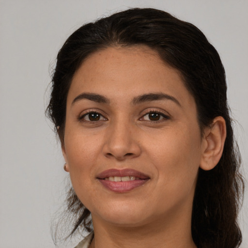 Joyful white young-adult female with medium  brown hair and brown eyes