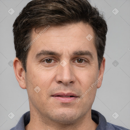 Joyful white adult male with short  brown hair and brown eyes