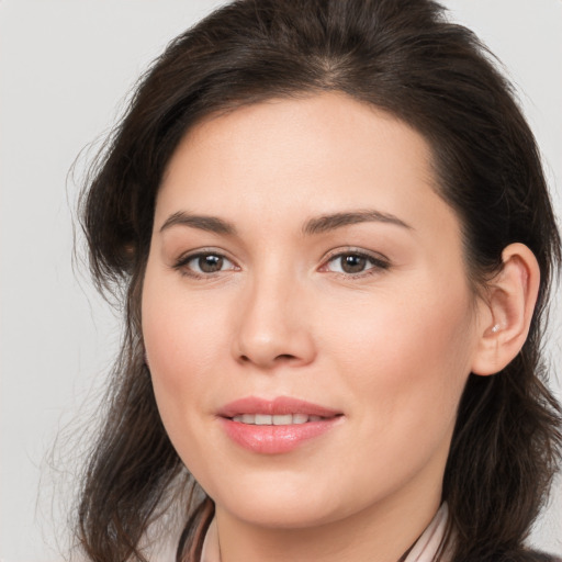 Joyful white young-adult female with long  brown hair and brown eyes