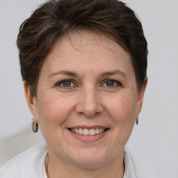 Joyful white adult female with short  brown hair and grey eyes