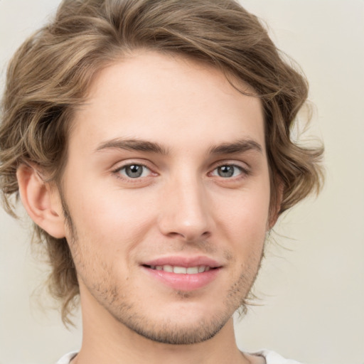 Joyful white young-adult male with medium  brown hair and brown eyes