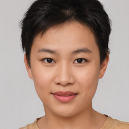 Joyful asian young-adult female with short  brown hair and brown eyes