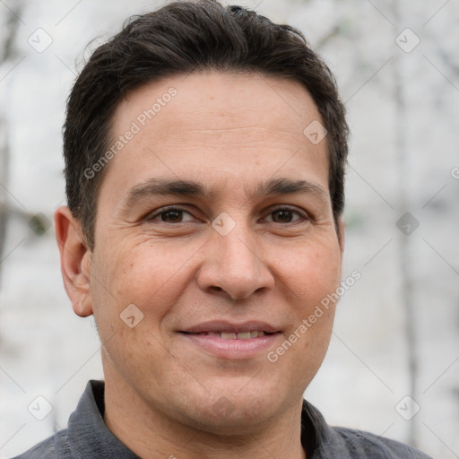 Joyful white adult male with short  brown hair and brown eyes