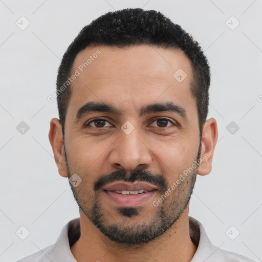 Joyful latino young-adult male with short  black hair and brown eyes