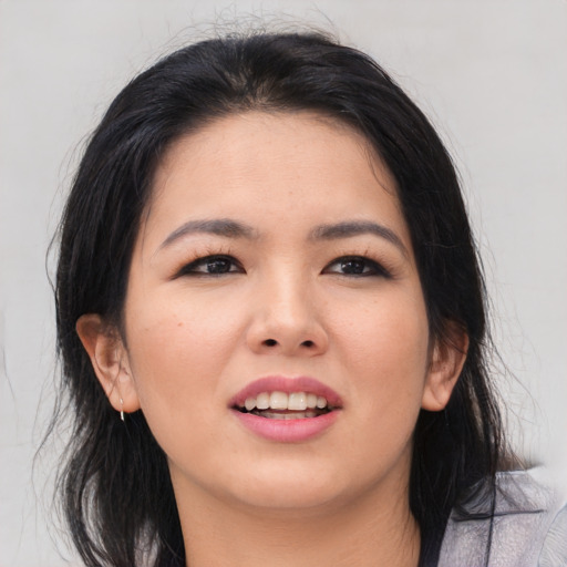Joyful asian young-adult female with medium  brown hair and brown eyes