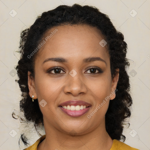 Joyful black young-adult female with long  brown hair and brown eyes