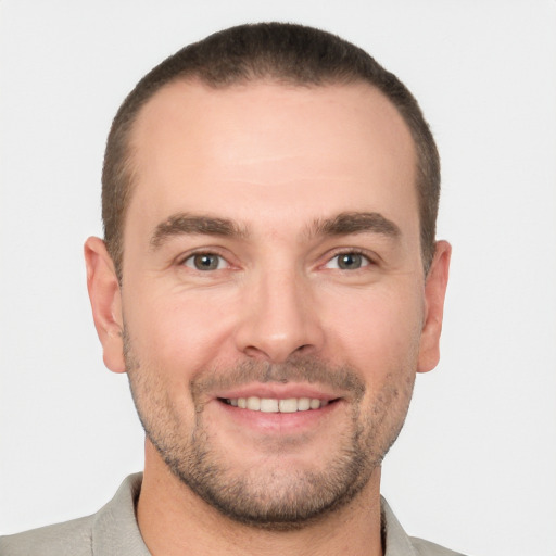 Joyful white young-adult male with short  brown hair and brown eyes