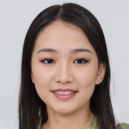 Joyful asian young-adult female with long  brown hair and brown eyes