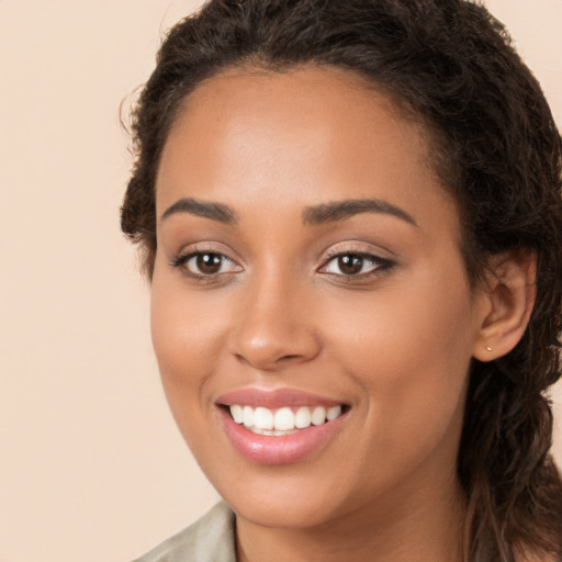 Joyful white young-adult female with long  brown hair and brown eyes