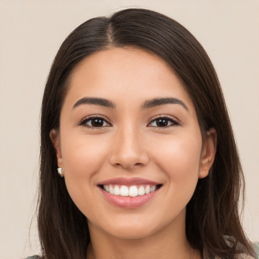 Joyful white young-adult female with long  brown hair and brown eyes