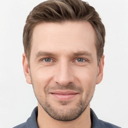 Joyful white adult male with short  brown hair and grey eyes