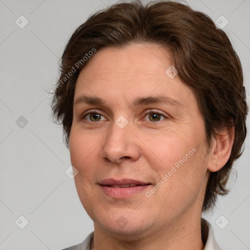 Joyful white adult female with medium  brown hair and brown eyes