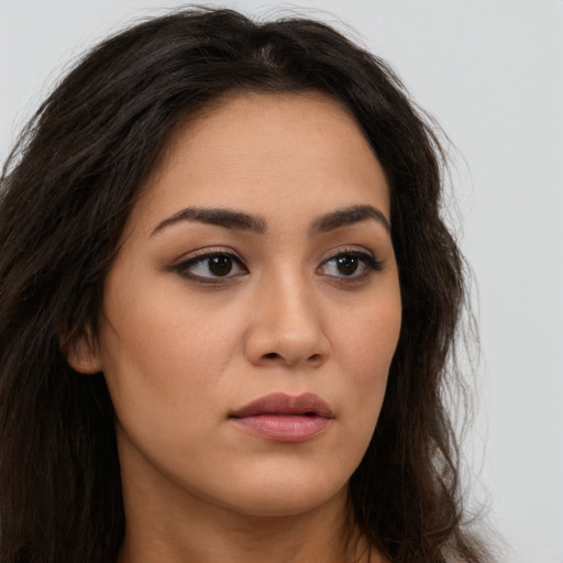 Neutral latino young-adult female with long  brown hair and brown eyes