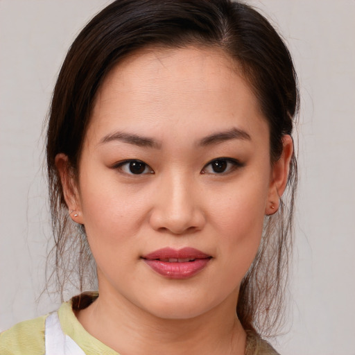 Joyful asian young-adult female with medium  brown hair and brown eyes