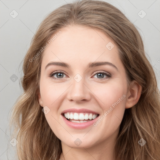 Joyful white young-adult female with long  brown hair and blue eyes