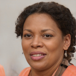 Joyful black adult female with short  brown hair and brown eyes