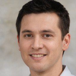 Joyful white young-adult male with short  brown hair and brown eyes