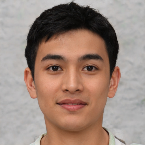 Joyful asian young-adult male with short  black hair and brown eyes