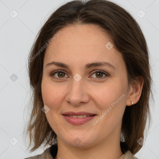 Joyful white adult female with medium  brown hair and grey eyes