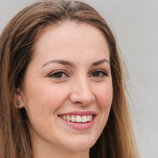 Joyful white young-adult female with long  brown hair and grey eyes