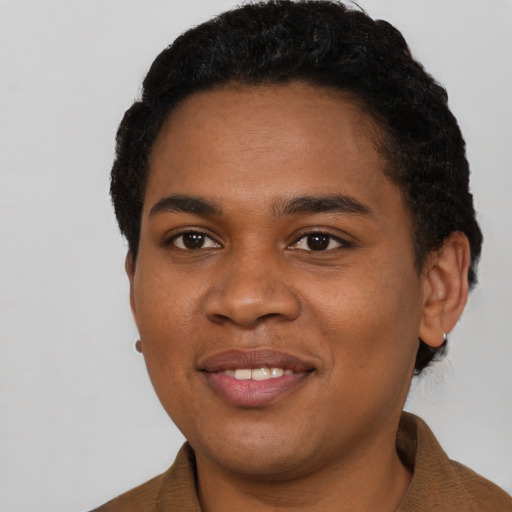 Joyful black young-adult female with short  black hair and brown eyes