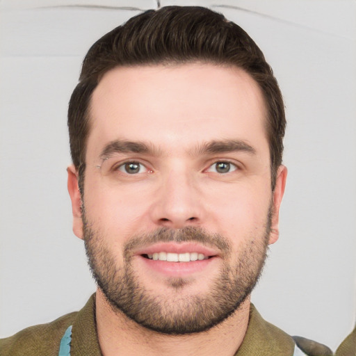 Joyful white young-adult male with short  brown hair and grey eyes