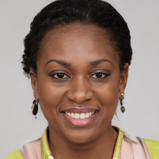 Joyful black young-adult female with short  brown hair and brown eyes