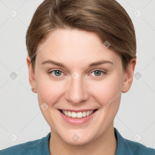 Joyful white young-adult female with short  brown hair and blue eyes