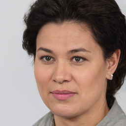 Joyful white adult female with medium  brown hair and brown eyes