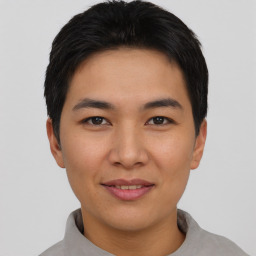 Joyful asian young-adult male with short  black hair and brown eyes