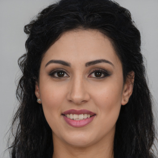 Joyful white young-adult female with long  brown hair and brown eyes