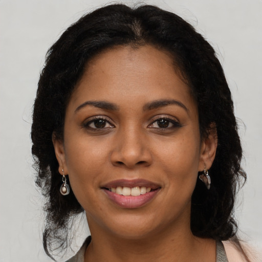 Joyful latino young-adult female with long  brown hair and brown eyes