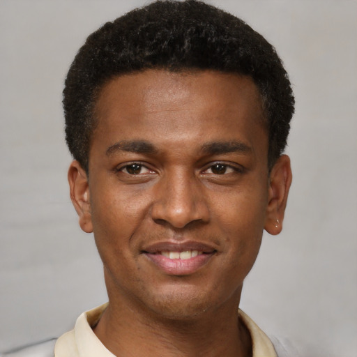 Joyful latino young-adult male with short  brown hair and brown eyes