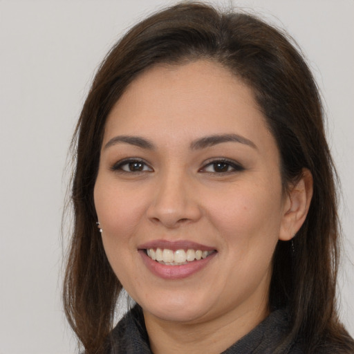 Joyful white young-adult female with long  brown hair and brown eyes