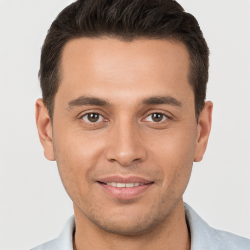 Joyful white young-adult male with short  brown hair and brown eyes