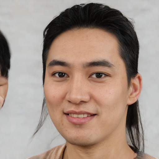 Joyful white young-adult male with medium  black hair and brown eyes