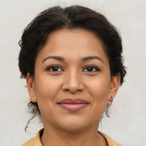 Joyful latino young-adult female with short  brown hair and brown eyes