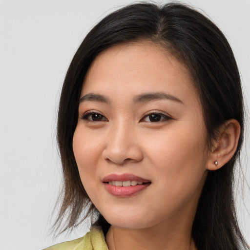 Joyful asian young-adult female with long  brown hair and brown eyes